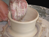 Pulling clay on wheel to increase height of bowl